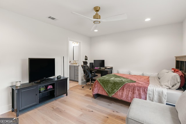 bedroom with ensuite bath, light wood-style floors, visible vents, and recessed lighting