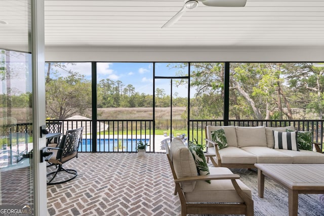 sunroom / solarium with ceiling fan and outdoor lounge area