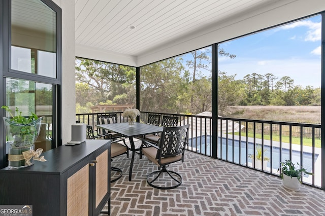 sunroom with outdoor dining space and plenty of natural light