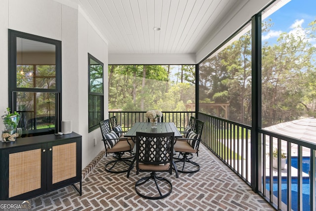 sunroom / solarium featuring outdoor dining space