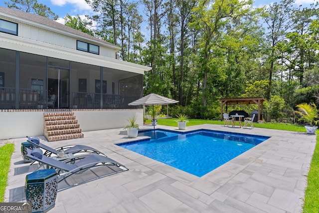 pool featuring a patio area, a sunroom, a gazebo, and fence