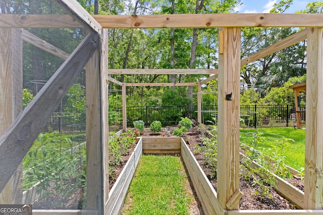 view of yard with fence and a garden