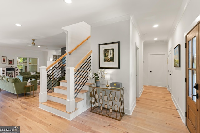 corridor featuring stairway, wood finished floors, and recessed lighting