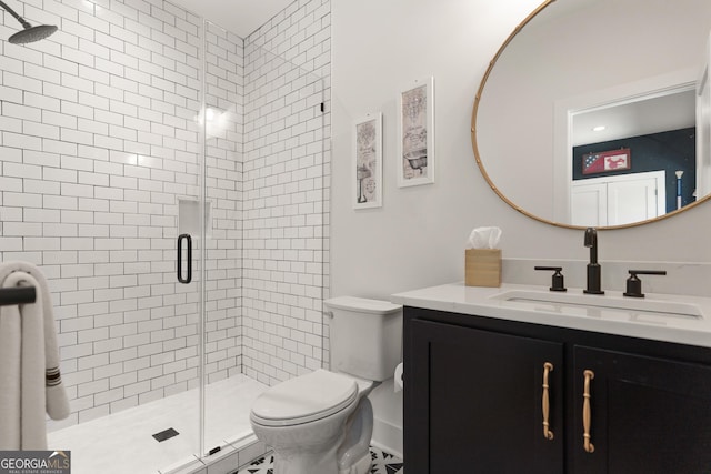 bathroom featuring vanity, toilet, and a stall shower