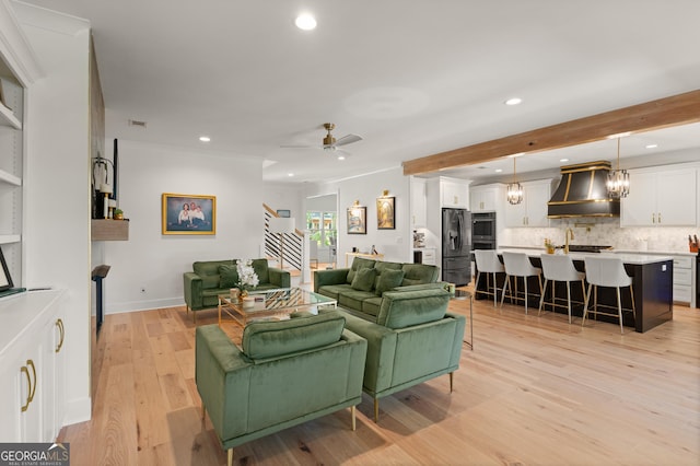 living room featuring light wood finished floors, stairway, baseboards, ceiling fan, and recessed lighting