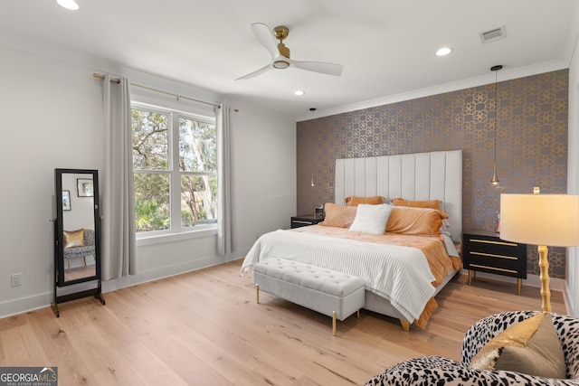 bedroom with light wood finished floors, crown molding, visible vents, baseboards, and recessed lighting