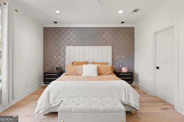bedroom with crown molding, baseboards, and light wood-style floors