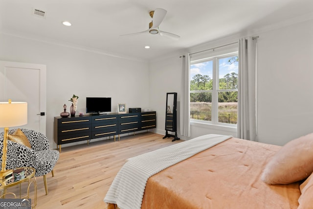 bedroom with ornamental molding, light wood-type flooring, visible vents, and recessed lighting
