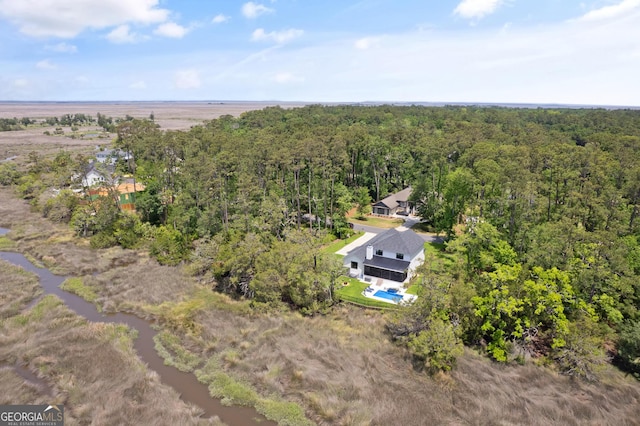 drone / aerial view featuring a wooded view