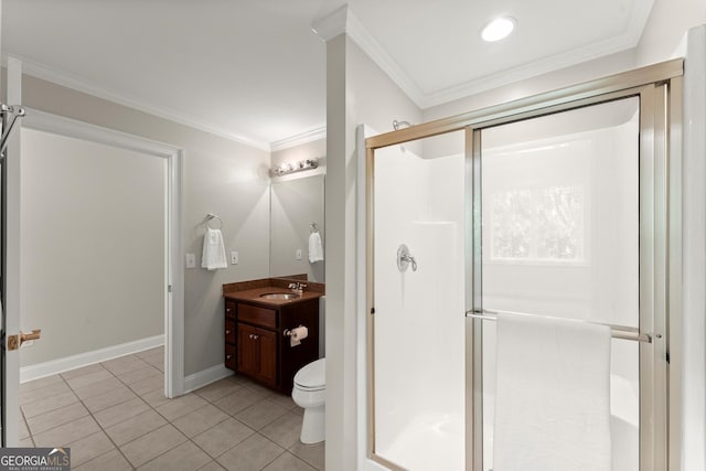 bathroom with a shower stall, tile patterned floors, crown molding, vanity, and toilet