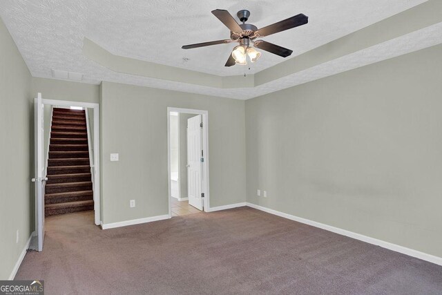 6345 Aarons Way, Flowery Branch, GA 30542 - unfurnished bedroom with a walk in closet, a textured ceiling, carpet floors, and baseboards