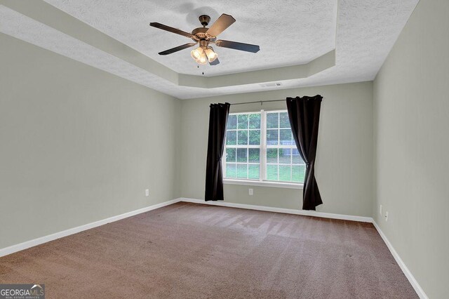 6345 Aarons Way, Flowery Branch, GA 30542 - carpeted empty room featuring a ceiling fan, a textured ceiling, baseboards, and a raised ceiling
