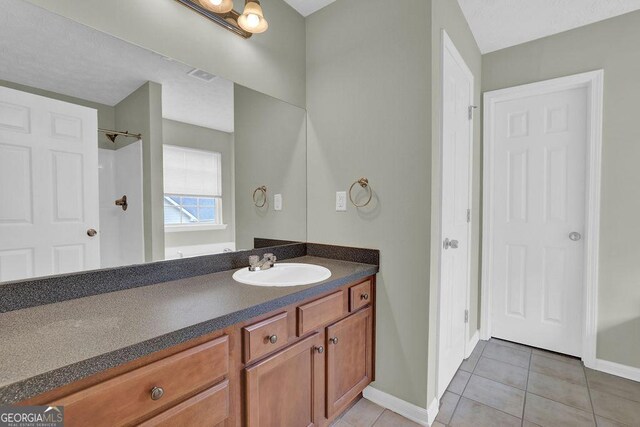 6345 Aarons Way, Flowery Branch, GA 30542 - bathroom with baseboards, tile patterned flooring, vanity, and visible vents