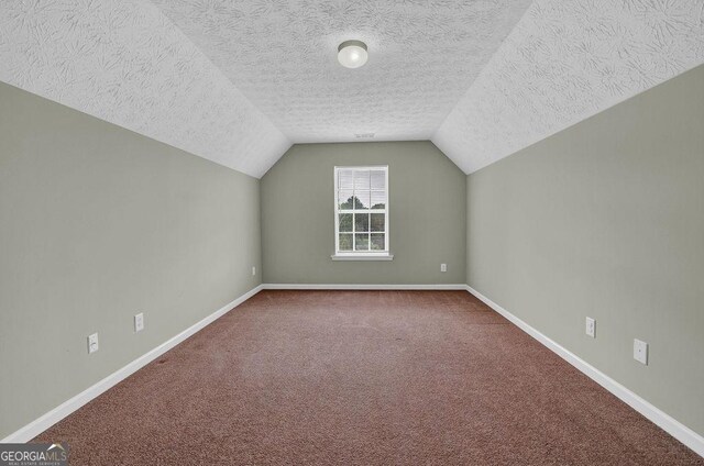 6345 Aarons Way, Flowery Branch, GA 30542 - bonus room with vaulted ceiling, a textured ceiling, carpet flooring, and baseboards