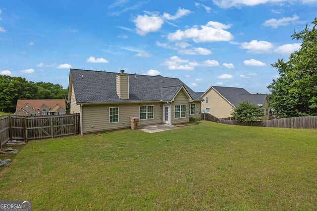 6345 Aarons Way, Flowery Branch, GA 30542 - back of property featuring a yard, a chimney, a patio, and a fenced backyard