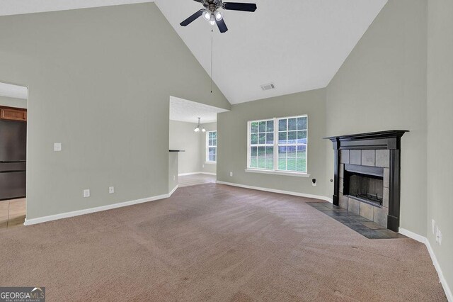 6345 Aarons Way, Flowery Branch, GA 30542 - unfurnished living room featuring carpet flooring, ceiling fan, visible vents, high vaulted ceiling, and a tile fireplace