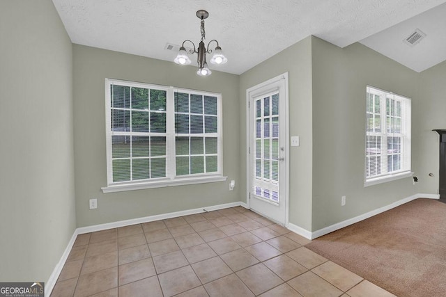 6345 Aarons Way, Flowery Branch, GA 30542 - unfurnished dining area featuring tile patterned floors, an inviting chandelier, visible vents, and plenty of natural light