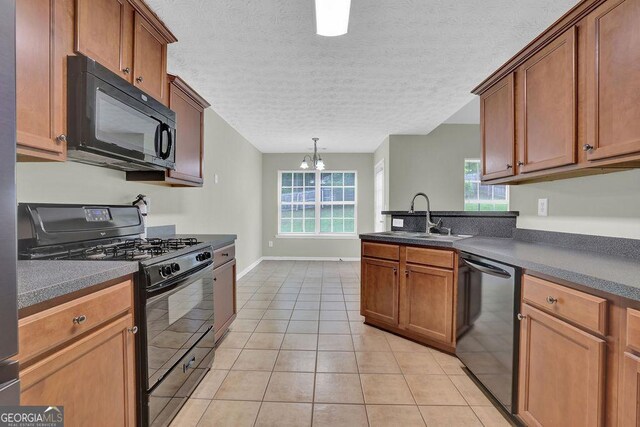6345 Aarons Way, Flowery Branch, GA 30542 - kitchen featuring a notable chandelier, light tile patterned floors, a sink, black appliances, and dark countertops