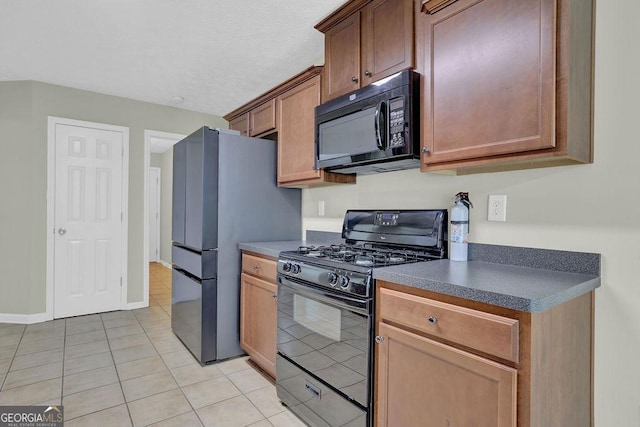6345 Aarons Way, Flowery Branch, GA 30542 - kitchen featuring light tile patterned floors, black appliances, and dark countertops