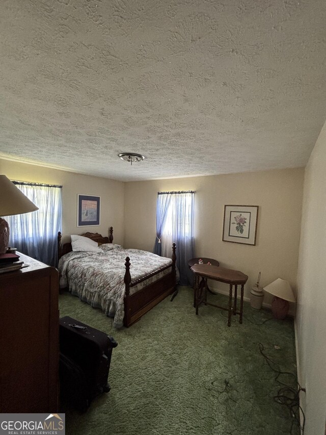 carpeted bedroom featuring a textured ceiling