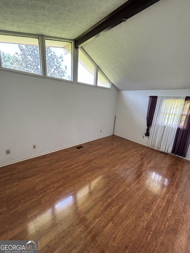 spare room with hardwood / wood-style flooring and baseboards