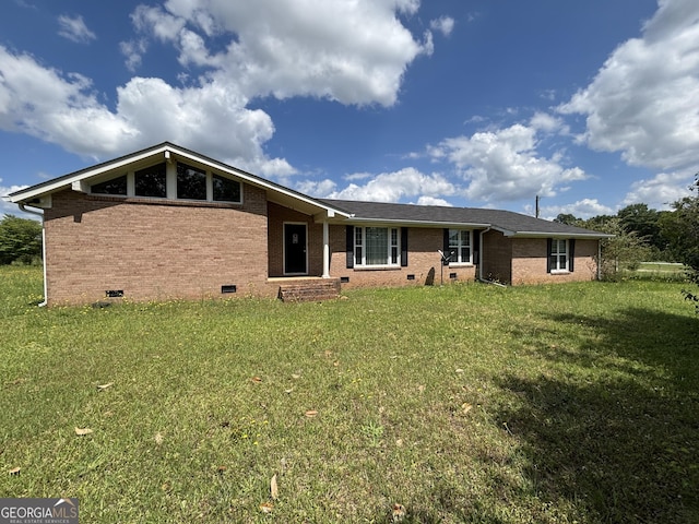 view of front facade with crawl space, brick siding, and a front lawn