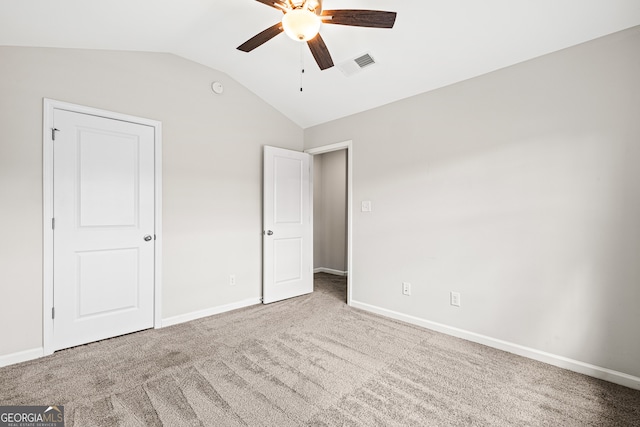 126 Ashton Pl, Newnan, GA 30265 - unfurnished bedroom with baseboards, ceiling fan, visible vents, vaulted ceiling, and carpet floors