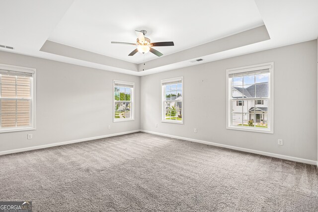 126 Ashton Pl, Newnan, GA 30265 - spare room featuring a tray ceiling, carpet floors, baseboards, and a ceiling fan