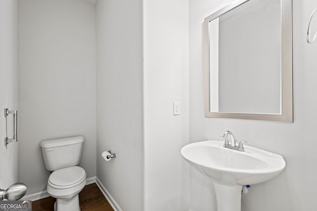 126 Ashton Pl, Newnan, GA 30265 - half bath featuring toilet, baseboards, and wood finished floors