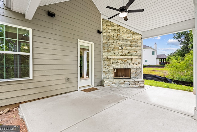 126 Ashton Pl, Newnan, GA 30265 - view of patio / terrace featuring an outdoor stone fireplace and a ceiling fan