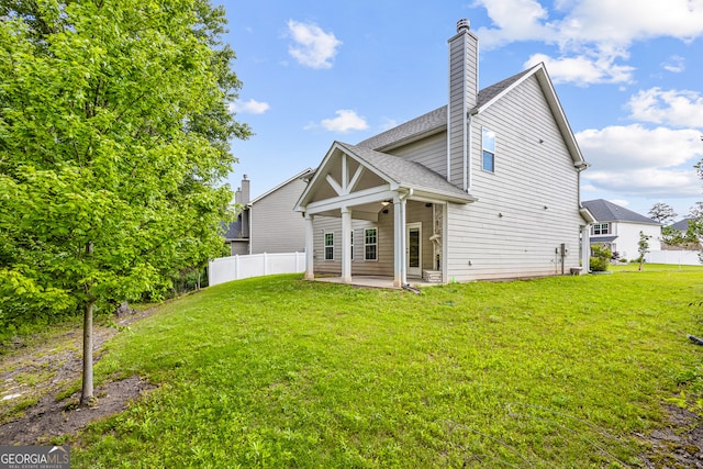 126 Ashton Pl, Newnan, GA 30265 - back of property featuring a yard, fence, a patio, and a chimney