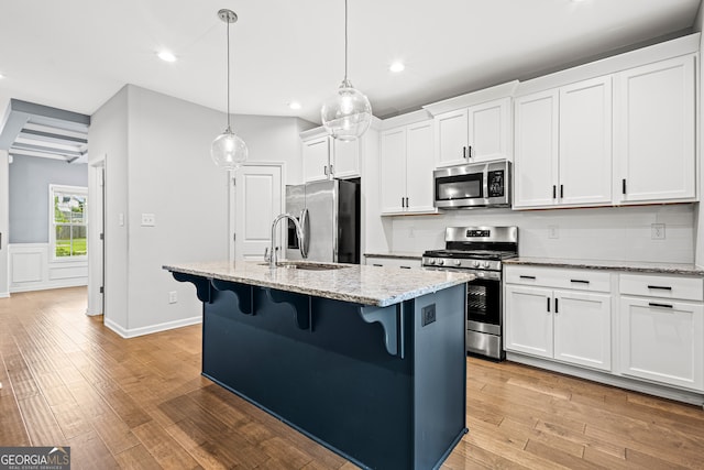 126 Ashton Pl, Newnan, GA 30265 - kitchen with appliances with stainless steel finishes, decorative backsplash, a breakfast bar area, and recessed lighting