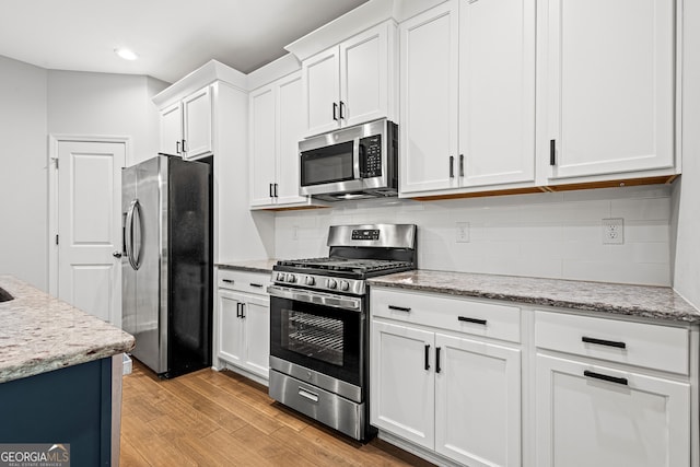 126 Ashton Pl, Newnan, GA 30265 - kitchen featuring recessed lighting, light wood finished floors, backsplash, white cabinets, and appliances with stainless steel finishes