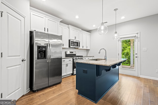126 Ashton Pl, Newnan, GA 30265 - kitchen featuring light stone counters, stainless steel appliances, white cabinets, and a sink