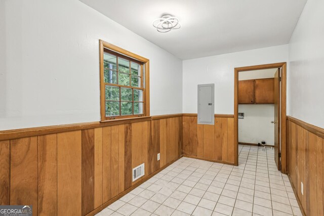 4074 Idlevale Dr, Tucker, GA 30084 - spare room with electric panel, wood walls, a wainscoted wall, light tile patterned flooring, and visible vents