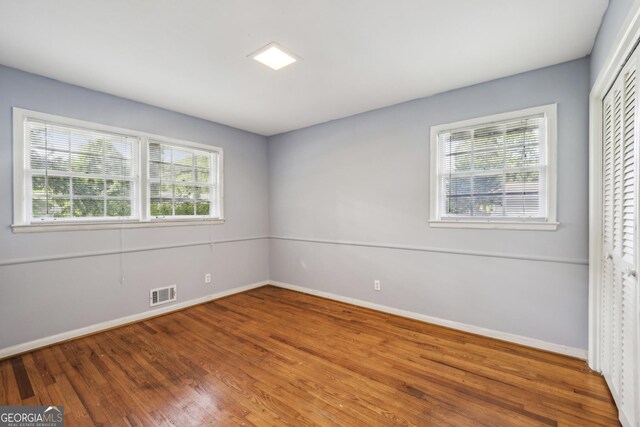 4074 Idlevale Dr, Tucker, GA 30084 - unfurnished room with plenty of natural light, baseboards, visible vents, and wood finished floors