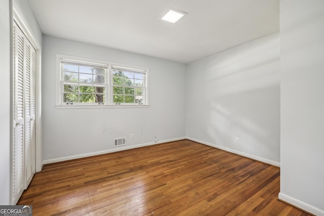 4074 Idlevale Dr, Tucker, GA 30084 - unfurnished bedroom featuring a closet, visible vents, wood finished floors, and baseboards
