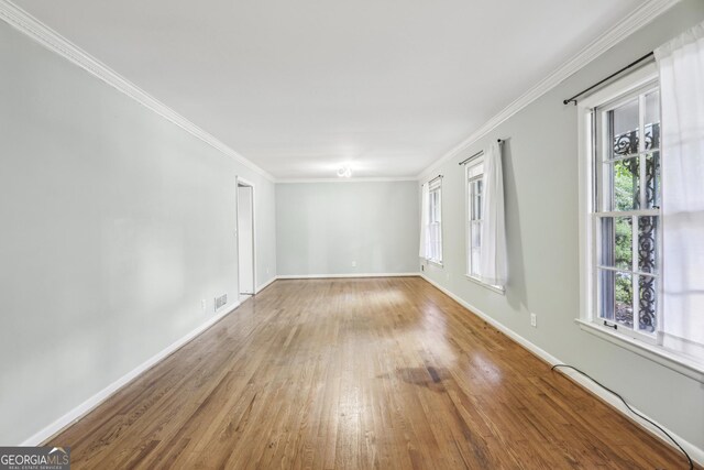 4074 Idlevale Dr, Tucker, GA 30084 - empty room with crown molding, visible vents, baseboards, and hardwood / wood-style floors