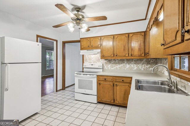 4074 Idlevale Dr, Tucker, GA 30084 - kitchen featuring under cabinet range hood, white appliances, a sink, and brown cabinets