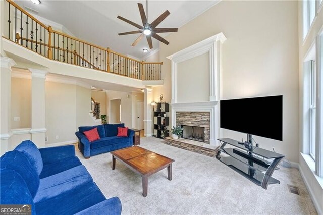 living area with carpet, a ceiling fan, stairs, plenty of natural light, and high vaulted ceiling