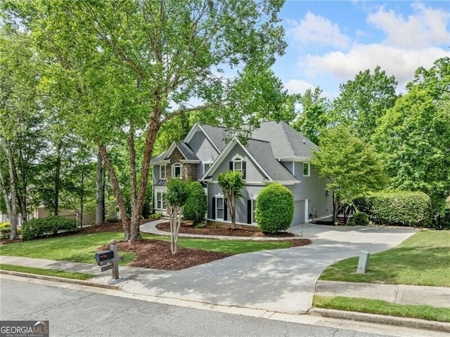 view of front of property with a front yard and concrete driveway