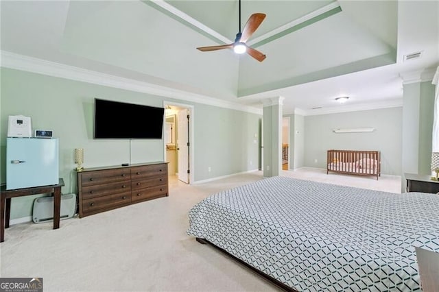 carpeted bedroom featuring ornamental molding, baseboards, decorative columns, and ceiling fan