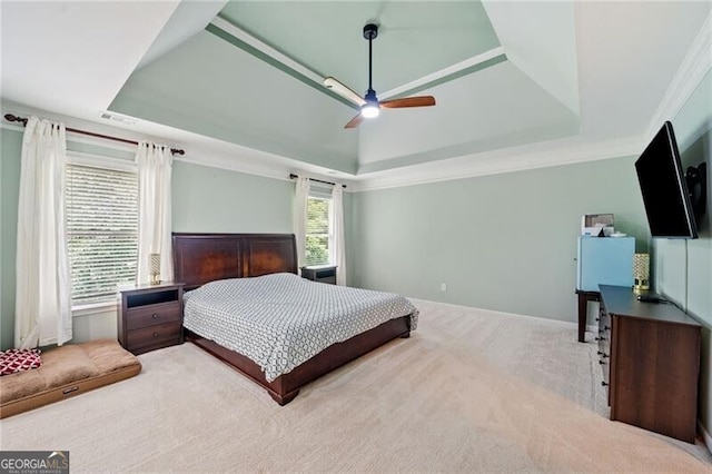 bedroom featuring a raised ceiling, carpet floors, and ceiling fan