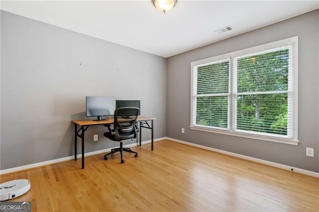 home office with wood finished floors and baseboards