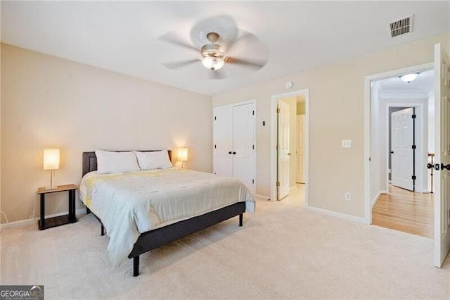 bedroom with light colored carpet, baseboards, and ceiling fan