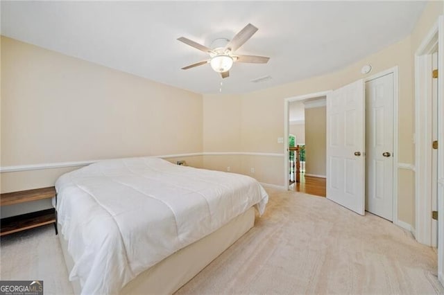 bedroom featuring ceiling fan, baseboards, and light colored carpet