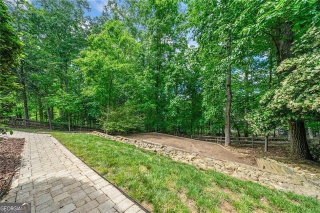 view of yard featuring fence and a patio