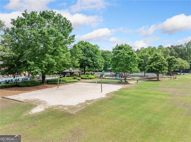 view of home's community with volleyball court and a lawn