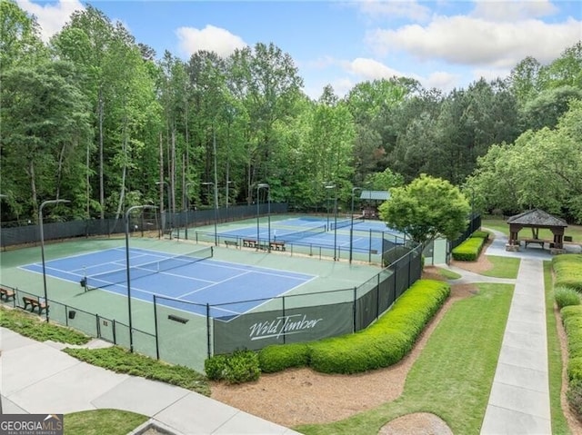 view of tennis court featuring a gazebo and fence