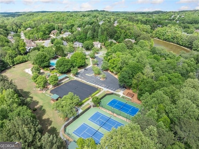 aerial view of property's location featuring a heavily wooded area